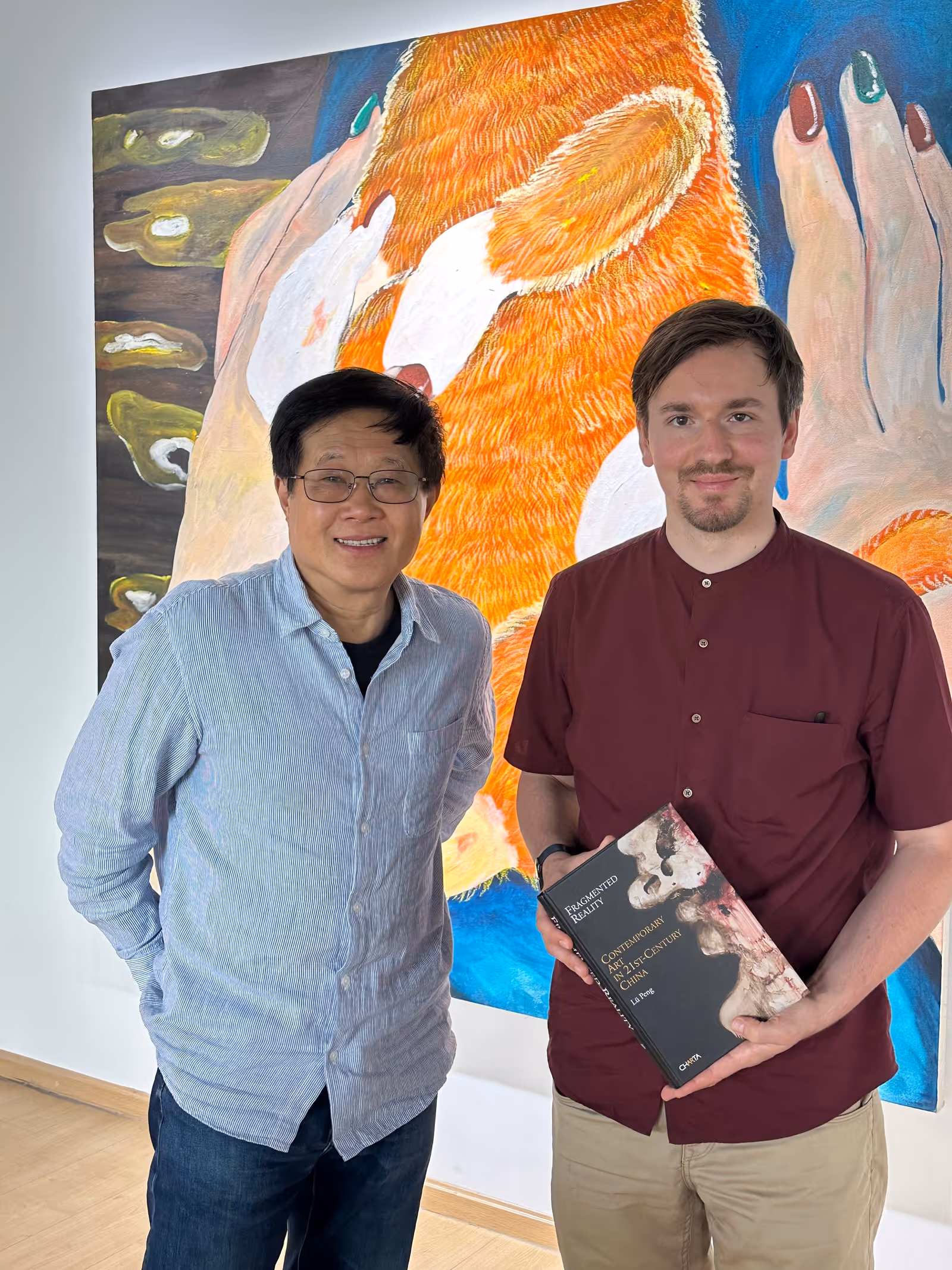 The photograph features Lü Peng (left) and Mr. Julian Lasinger, Deputy Consul General of Germany in Chengdu (right), May 5, 2024